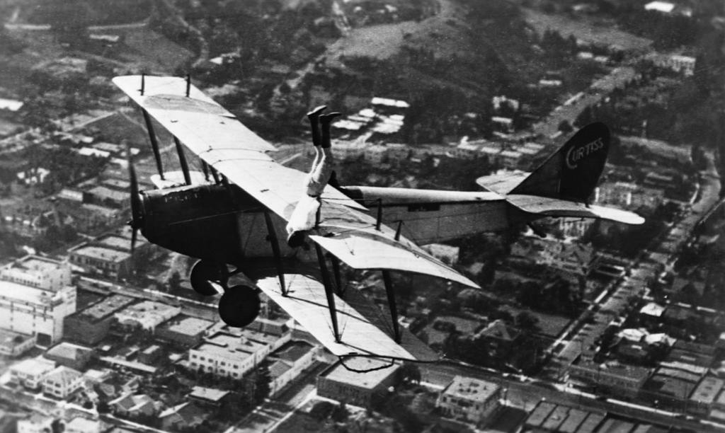 Каскадер Ормер Локлир делает стойку на руках на крыле биплана Curtiss JN-4D в 1920 году