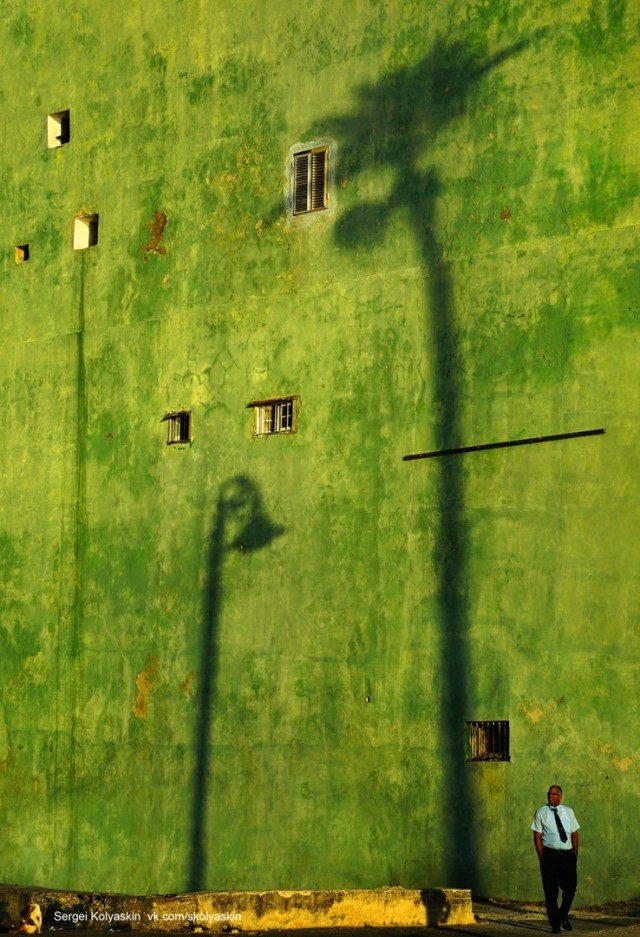 City shadows on a yellow-green wall, Cuba. Photographer Sergey Kolyaskin