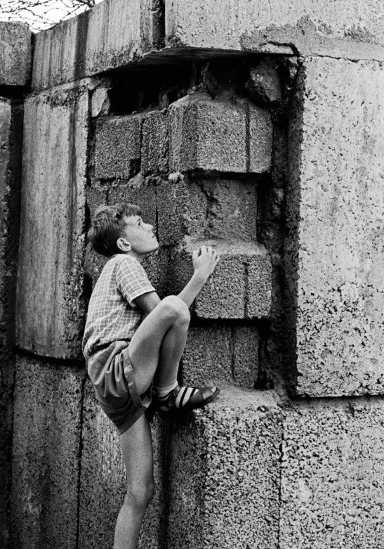Мальчик взбирается на Берлинскую стену, Берлин, Германия, 1963 год. Фотограф Томас Хёпкер