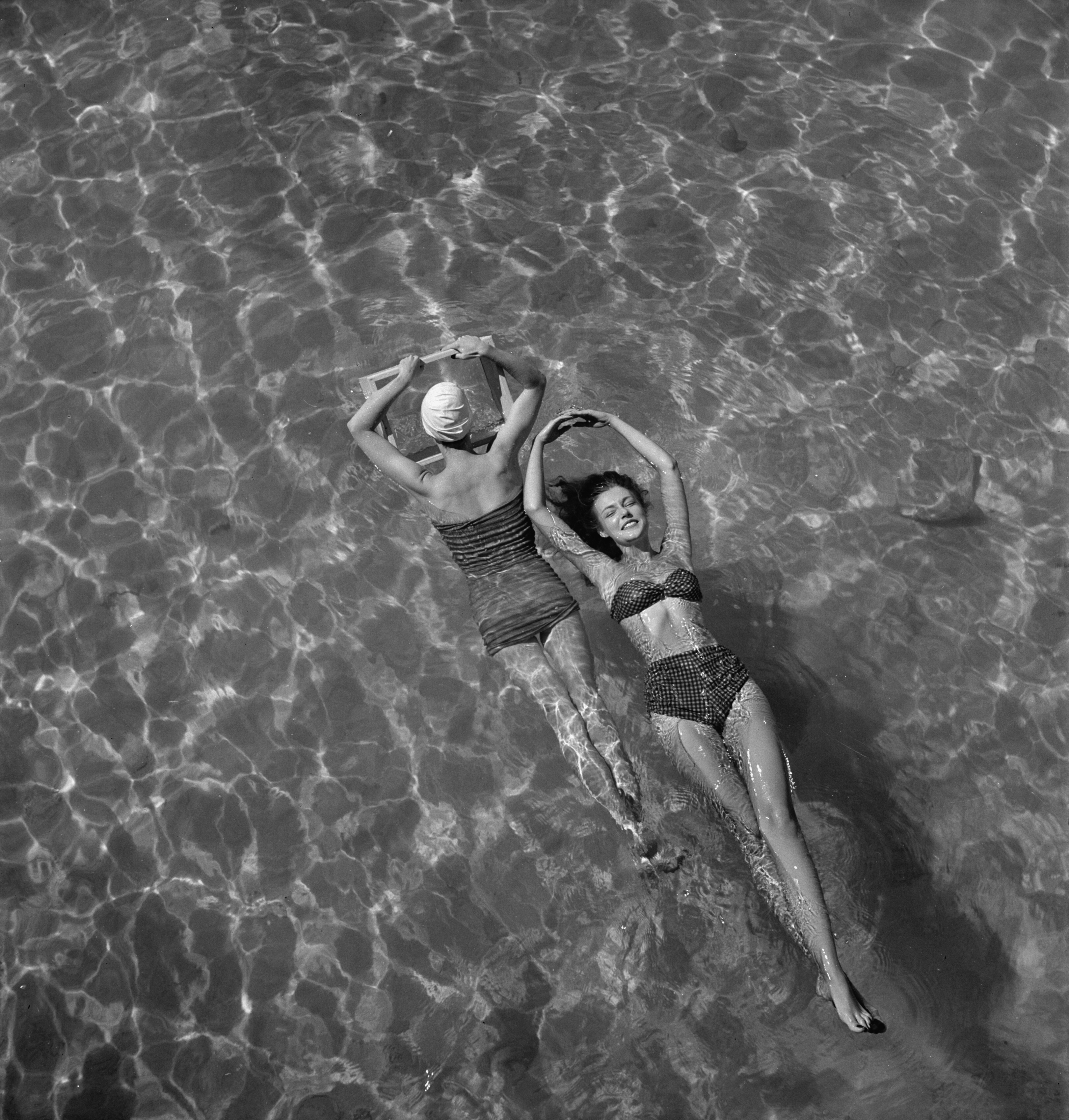 Модели в купальниках плавают в бассейне, 1948. Фотограф Тони Фрисселл