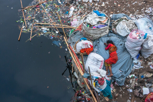2nd place in the category "Environmental Defender", 2021. A woman at a garbage dump in Dhaka, Bangladesh.  Written by Saiful Islam