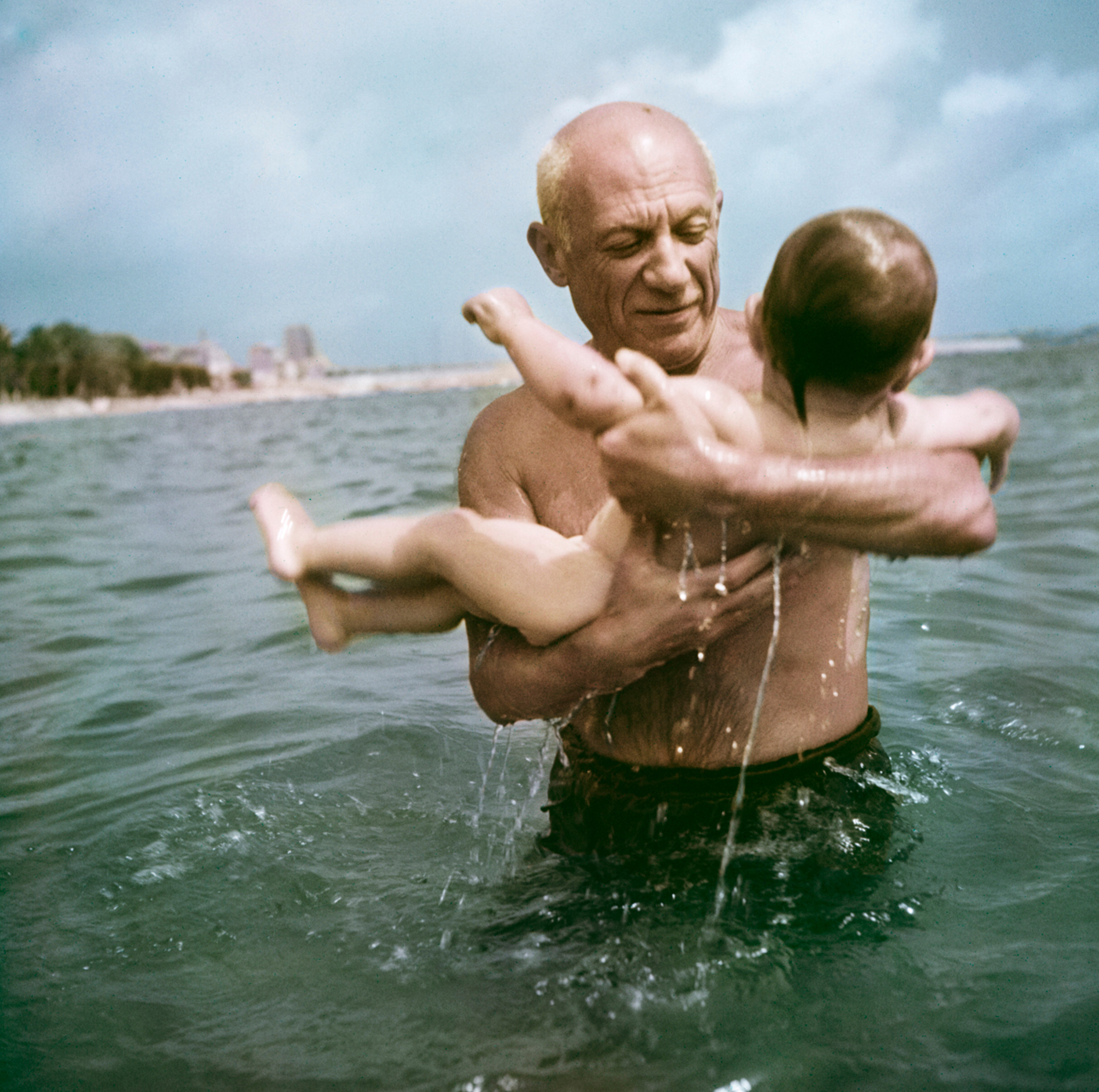 Пабло Пикассо играет в воде со своим сыном Клодом, Валлорис, Франция, 1948 год.  Фотограф Роберт Капа